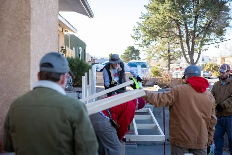 Several people working on building a ramp